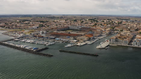 Global-aerial-view-of-Marseillan-town-and-port-during-a-sunny-windy-day-Thau